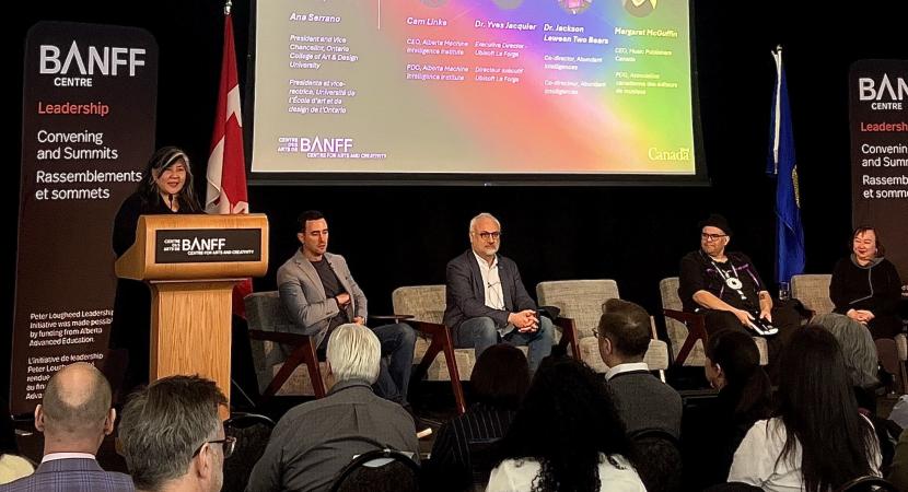 Photograph of Ana Serrano talking at the Banff National AI Summit in front of a crowd