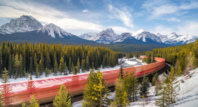 Photo of a red train in the forest in Alberta